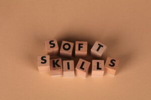 Wooden letter blocks spell out 'Soft Skills', highlighting business and personal development concepts.